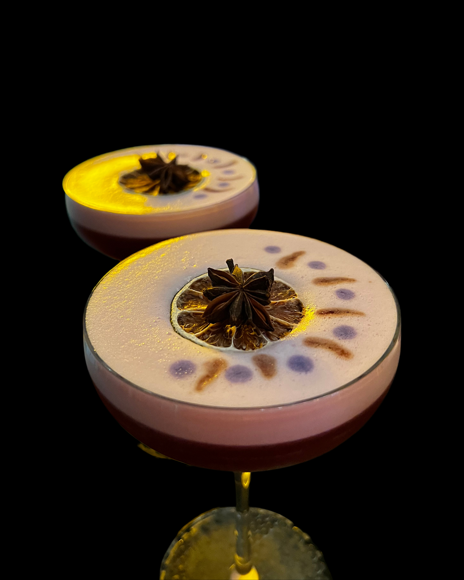 Vegan cocktail foam topped with botanical garnish, made without egg white